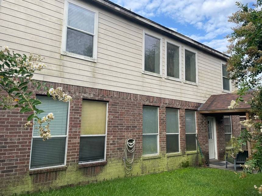 Before pressure washing: siding and brick